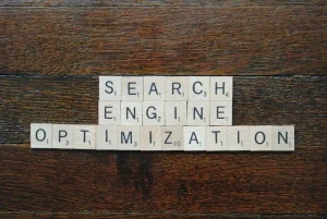 Square wood letters spelling search engine optimization on a brown table 